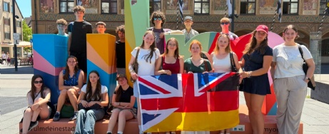 Students standing outside with UK and German flags